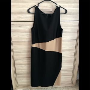 Sleeveless asymmetric business dress with front side slit. Gently worn.